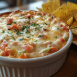 A bowl of creamy Rotel dip with visible diced tomatoes and chilies, served with tortilla chips—the perfect easy Rotel dip recipe for parties.